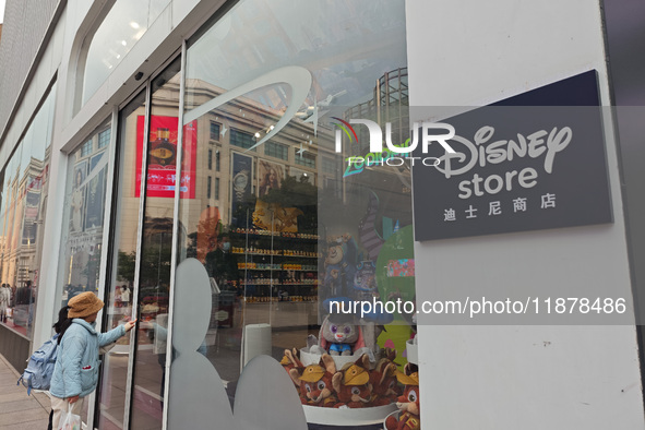 Customers walk past a newly opened Disney store on Nanjing Road Pedestrian Street in Shanghai, China, on December 18, 2024. 