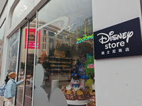 Customers walk past a newly opened Disney store on Nanjing Road Pedestrian Street in Shanghai, China, on December 18, 2024. (