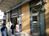 An Alpha Bank branch is in Athens, Greece, on December 18, 2024. Greek lenders face an impact of about 350 million euros ($368 million) in 2...