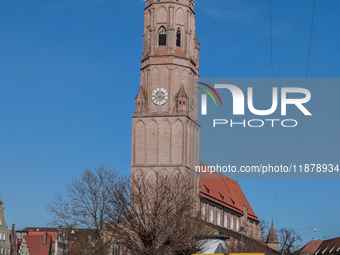 A DHL delivery van parks near a historic church in Landshut, Bavaria, Germany, on March 9, 2024. (