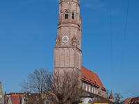 A DHL delivery van parks near a historic church in Landshut, Bavaria, Germany, on March 9, 2024. (