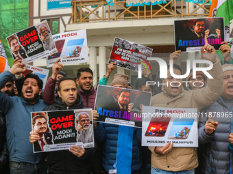 Members of the youth wing of the Indian National Congress party shout slogans and hold placards during a protest in Srinagar, Jammu and Kash...