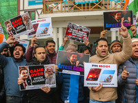 Members of the youth wing of the Indian National Congress party shout slogans and hold placards during a protest in Srinagar, Jammu and Kash...