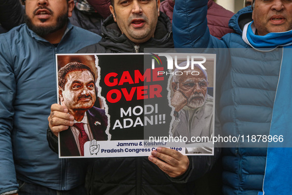 Members of the youth wing of the Indian National Congress party shout slogans and hold placards during a protest in Srinagar, Jammu and Kash...