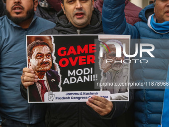 Members of the youth wing of the Indian National Congress party shout slogans and hold placards during a protest in Srinagar, Jammu and Kash...