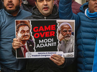 Members of the youth wing of the Indian National Congress party shout slogans and hold placards during a protest in Srinagar, Jammu and Kash...