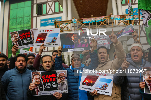 Members of the youth wing of the Indian National Congress party shout slogans and hold placards during a protest in Srinagar, Jammu and Kash...