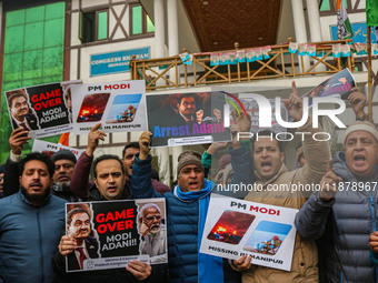 Members of the youth wing of the Indian National Congress party shout slogans and hold placards during a protest in Srinagar, Jammu and Kash...