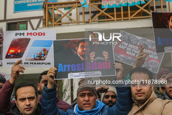 Members of the youth wing of the Indian National Congress party shout slogans and hold placards during a protest in Srinagar, Jammu and Kash...