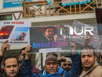 Members of the youth wing of the Indian National Congress party shout slogans and hold placards during a protest in Srinagar, Jammu and Kash...