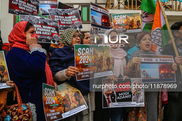 Members of the youth wing of the Indian National Congress party shout slogans and hold placards during a protest in Srinagar, Jammu and Kash...