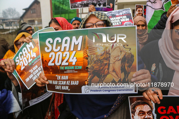 Members of the youth wing of the Indian National Congress party shout slogans and hold placards during a protest in Srinagar, Jammu and Kash...