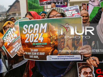 Members of the youth wing of the Indian National Congress party shout slogans and hold placards during a protest in Srinagar, Jammu and Kash...