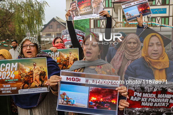 Members of the youth wing of the Indian National Congress party shout slogans and hold placards during a protest in Srinagar, Jammu and Kash...