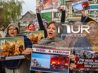 Members of the youth wing of the Indian National Congress party shout slogans and hold placards during a protest in Srinagar, Jammu and Kash...