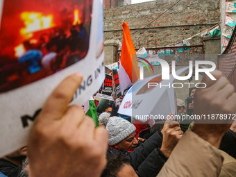 Members of the youth wing of the Indian National Congress party shout slogans and hold placards during a protest in Srinagar, Jammu and Kash...