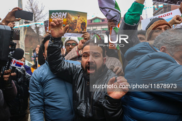 Members of the youth wing of the Indian National Congress party shout slogans and hold placards during a protest in Srinagar, Jammu and Kash...