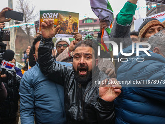 Members of the youth wing of the Indian National Congress party shout slogans and hold placards during a protest in Srinagar, Jammu and Kash...