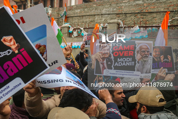 Members of the youth wing of the Indian National Congress party shout slogans and hold placards during a protest in Srinagar, Jammu and Kash...