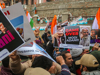 Members of the youth wing of the Indian National Congress party shout slogans and hold placards during a protest in Srinagar, Jammu and Kash...