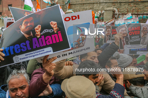 Members of the youth wing of the Indian National Congress party shout slogans and hold placards during a protest in Srinagar, Jammu and Kash...