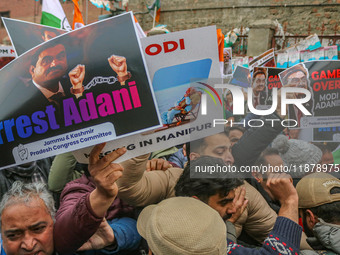 Members of the youth wing of the Indian National Congress party shout slogans and hold placards during a protest in Srinagar, Jammu and Kash...