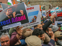 Members of the youth wing of the Indian National Congress party shout slogans and hold placards during a protest in Srinagar, Jammu and Kash...