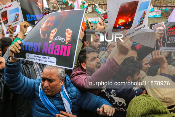 Members of the youth wing of the Indian National Congress party shout slogans and hold placards during a protest in Srinagar, Jammu and Kash...