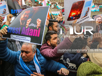 Members of the youth wing of the Indian National Congress party shout slogans and hold placards during a protest in Srinagar, Jammu and Kash...