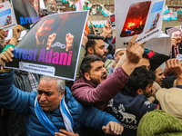 Members of the youth wing of the Indian National Congress party shout slogans and hold placards during a protest in Srinagar, Jammu and Kash...