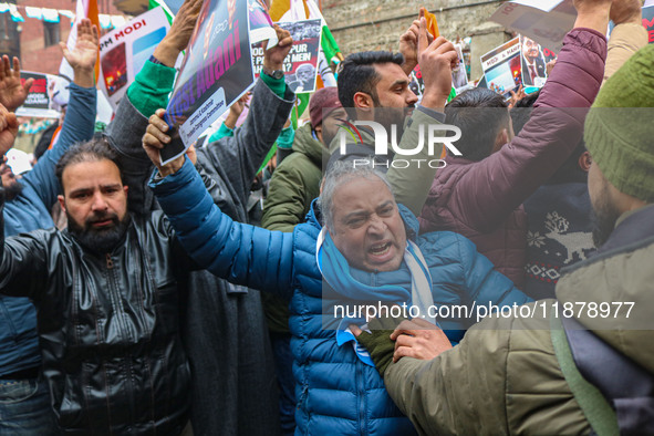 Members of the youth wing of the Indian National Congress party shout slogans and hold placards during a protest in Srinagar, Jammu and Kash...