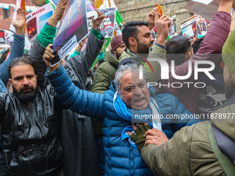 Members of the youth wing of the Indian National Congress party shout slogans and hold placards during a protest in Srinagar, Jammu and Kash...