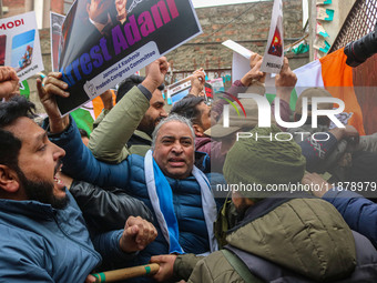 Members of the youth wing of the Indian National Congress party shout slogans and hold placards during a protest in Srinagar, Jammu and Kash...