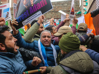 Members of the youth wing of the Indian National Congress party shout slogans and hold placards during a protest in Srinagar, Jammu and Kash...