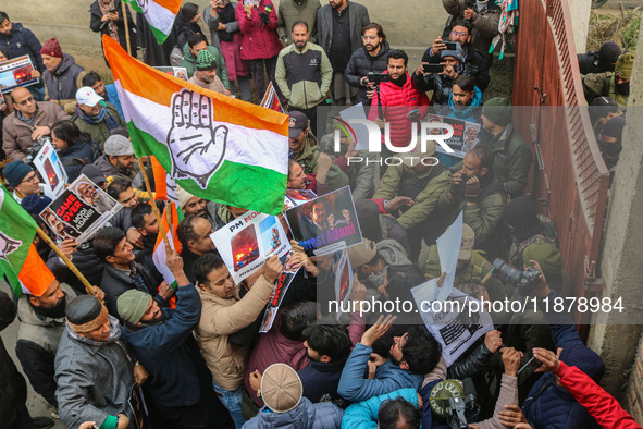 Members of the youth wing of the Indian National Congress party shout slogans and hold placards during a protest in Srinagar, Jammu and Kash...