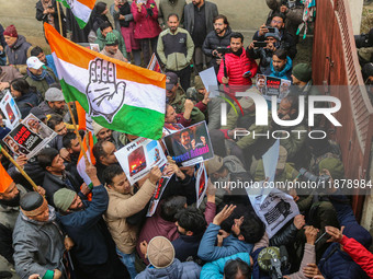 Members of the youth wing of the Indian National Congress party shout slogans and hold placards during a protest in Srinagar, Jammu and Kash...