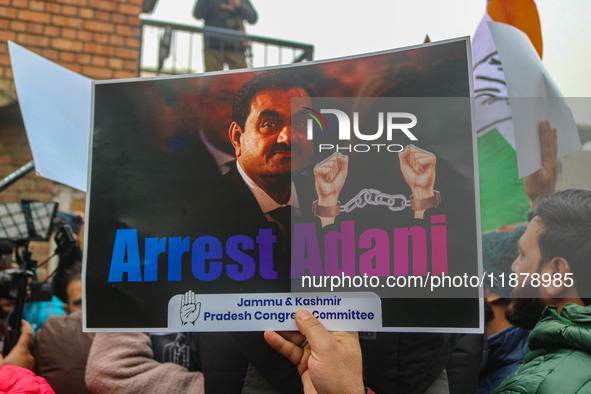 Members of the youth wing of the Indian National Congress party shout slogans and hold placards during a protest in Srinagar, Jammu and Kash...