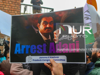 Members of the youth wing of the Indian National Congress party shout slogans and hold placards during a protest in Srinagar, Jammu and Kash...