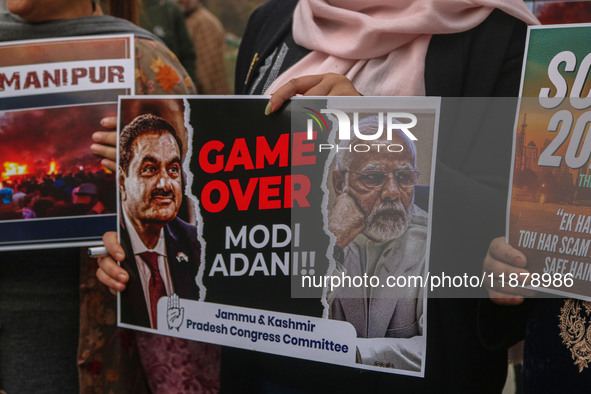 Members of the youth wing of the Indian National Congress party shout slogans and hold placards during a protest in Srinagar, Jammu and Kash...