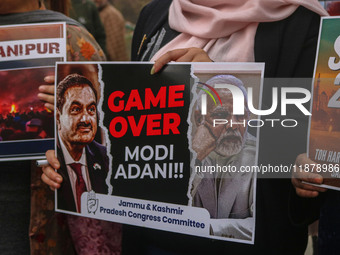 Members of the youth wing of the Indian National Congress party shout slogans and hold placards during a protest in Srinagar, Jammu and Kash...