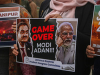 Members of the youth wing of the Indian National Congress party shout slogans and hold placards during a protest in Srinagar, Jammu and Kash...