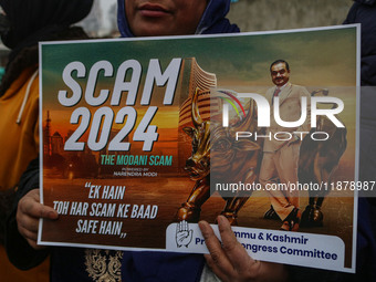 Members of the youth wing of the Indian National Congress party shout slogans and hold placards during a protest in Srinagar, Jammu and Kash...