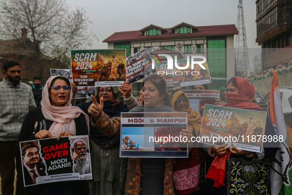 Members of the youth wing of the Indian National Congress party shout slogans and hold placards during a protest in Srinagar, Jammu and Kash...