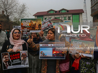 Members of the youth wing of the Indian National Congress party shout slogans and hold placards during a protest in Srinagar, Jammu and Kash...