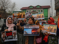 Members of the youth wing of the Indian National Congress party shout slogans and hold placards during a protest in Srinagar, Jammu and Kash...