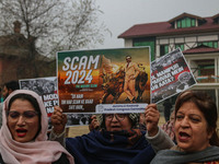 Members of the youth wing of the Indian National Congress party shout slogans and hold placards during a protest in Srinagar, Jammu and Kash...