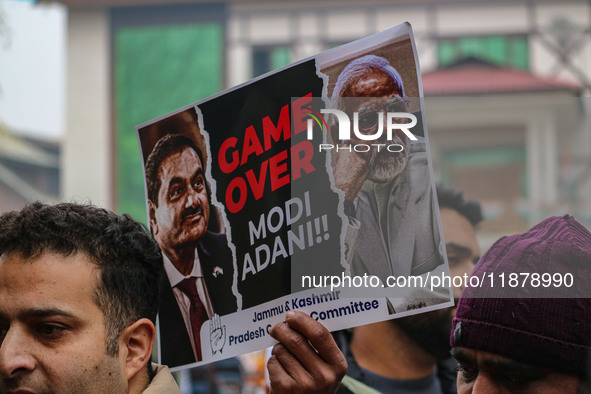 Members of the youth wing of the Indian National Congress party shout slogans and hold placards during a protest in Srinagar, Jammu and Kash...