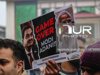 Members of the youth wing of the Indian National Congress party shout slogans and hold placards during a protest in Srinagar, Jammu and Kash...