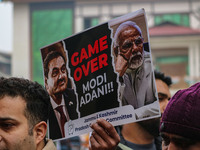 Members of the youth wing of the Indian National Congress party shout slogans and hold placards during a protest in Srinagar, Jammu and Kash...