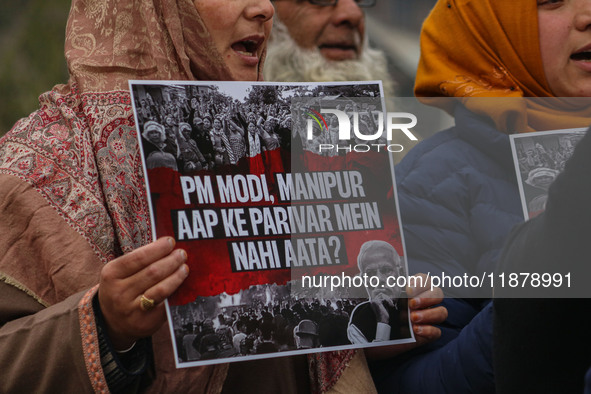 Members of the youth wing of the Indian National Congress party shout slogans and hold placards during a protest in Srinagar, Jammu and Kash...